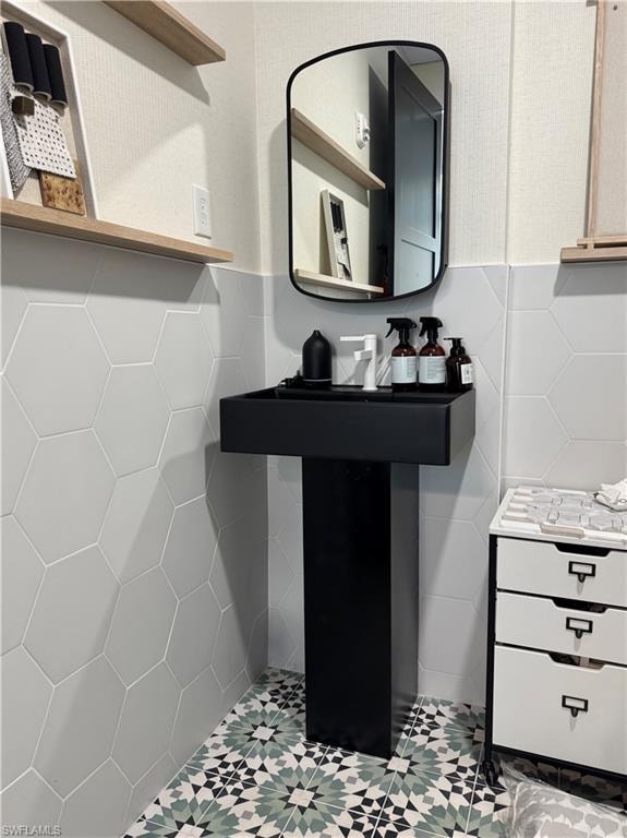 Bathroom with tile walls and a wainscoted wall