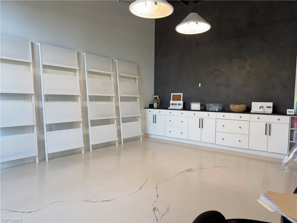 Unfurnished dining area featuring concrete flooring