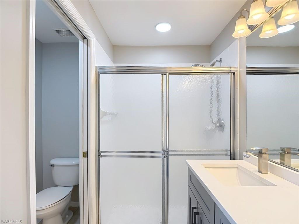 Bathroom featuring vanity and a stall shower