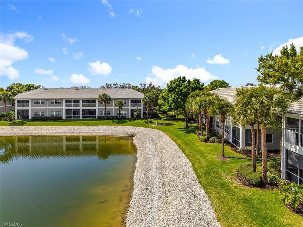 View of property's community with a water view and a sunroom