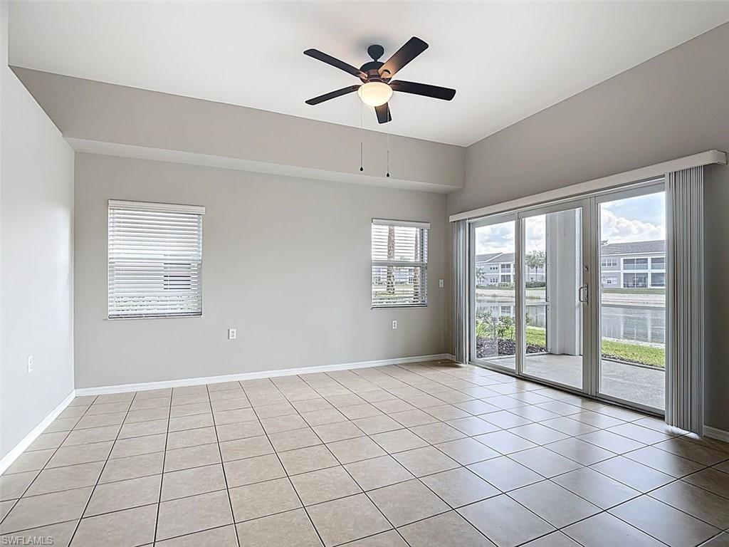 Spare room with ceiling fan and light tile patterned floors