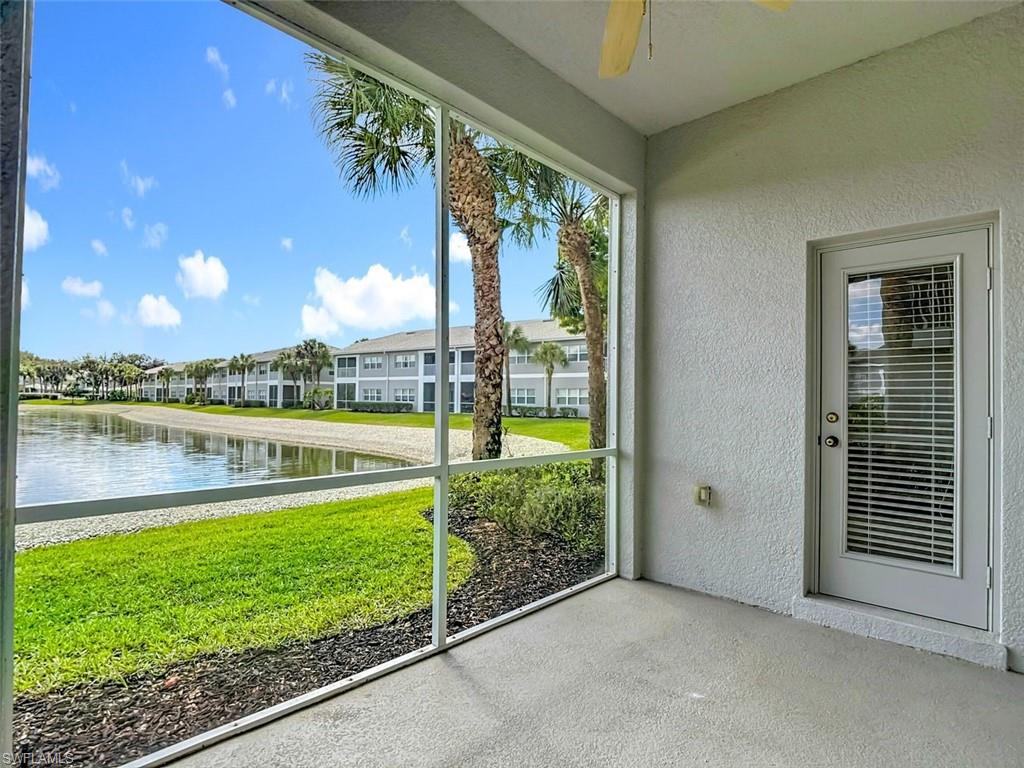 Unfurnished sunroom with a ceiling fan and a water view