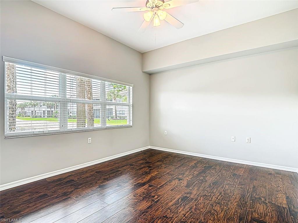 Spare room with ceiling fan and dark wood finished floors