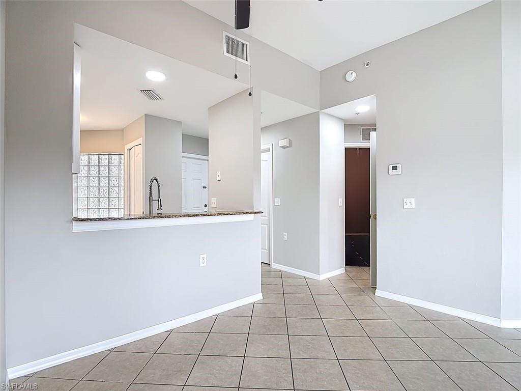 Spare room with ceiling fan and light tile patterned flooring