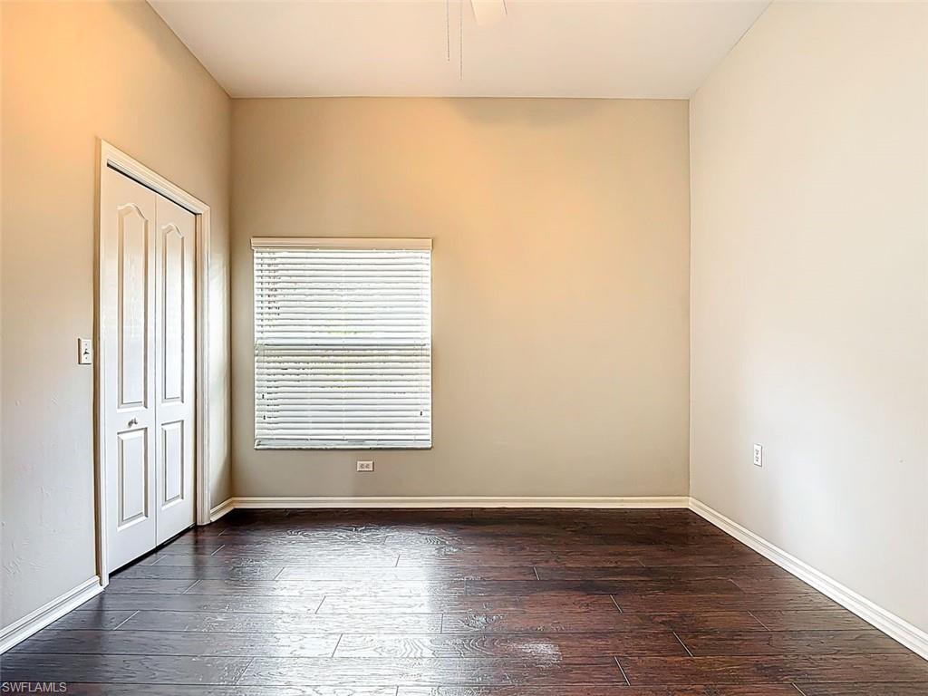 Unfurnished bedroom with dark wood-type flooring and a closet
