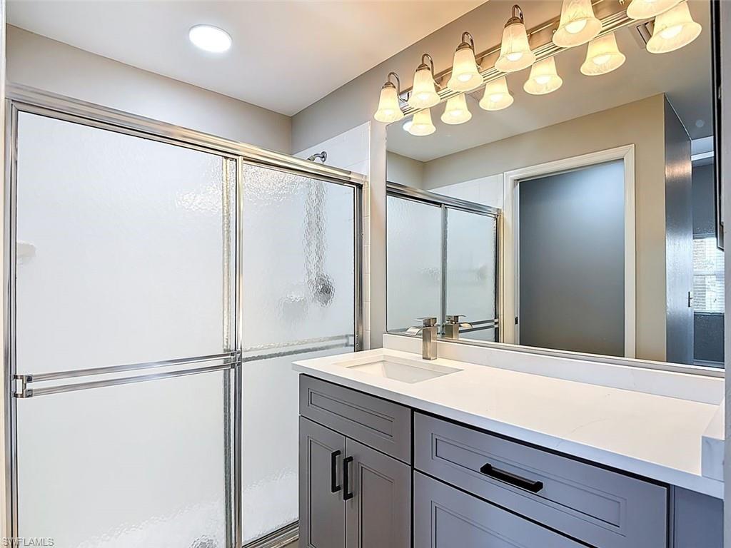 Full bathroom featuring vanity and a stall shower