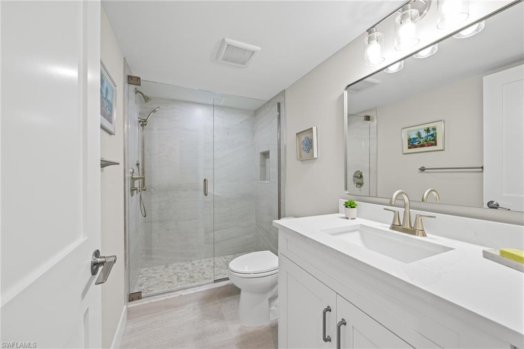 Bathroom featuring vanity and a shower stall