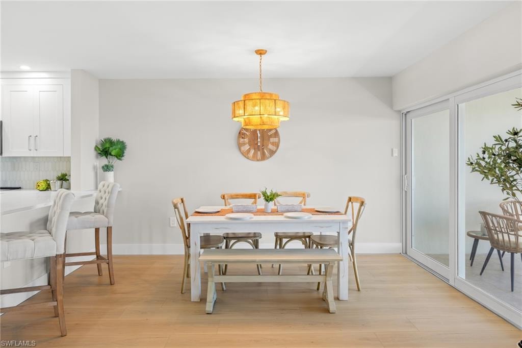 Dining room featuring light wood-type flooring and baseboards