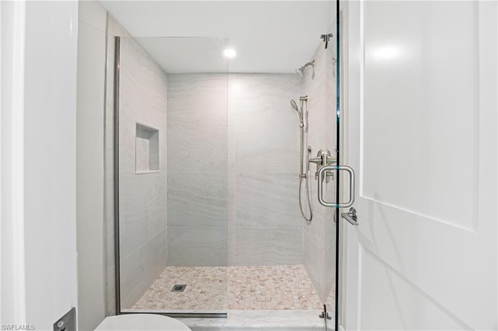 Bathroom featuring a shower stall and recessed lighting