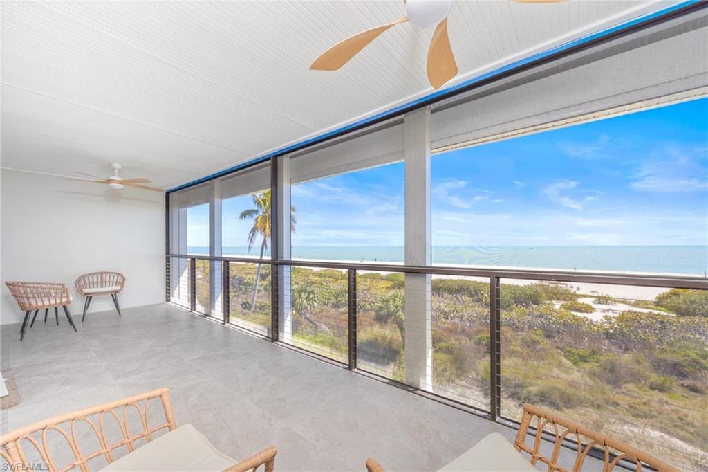 Sunroom / solarium with expansive windows and a water view