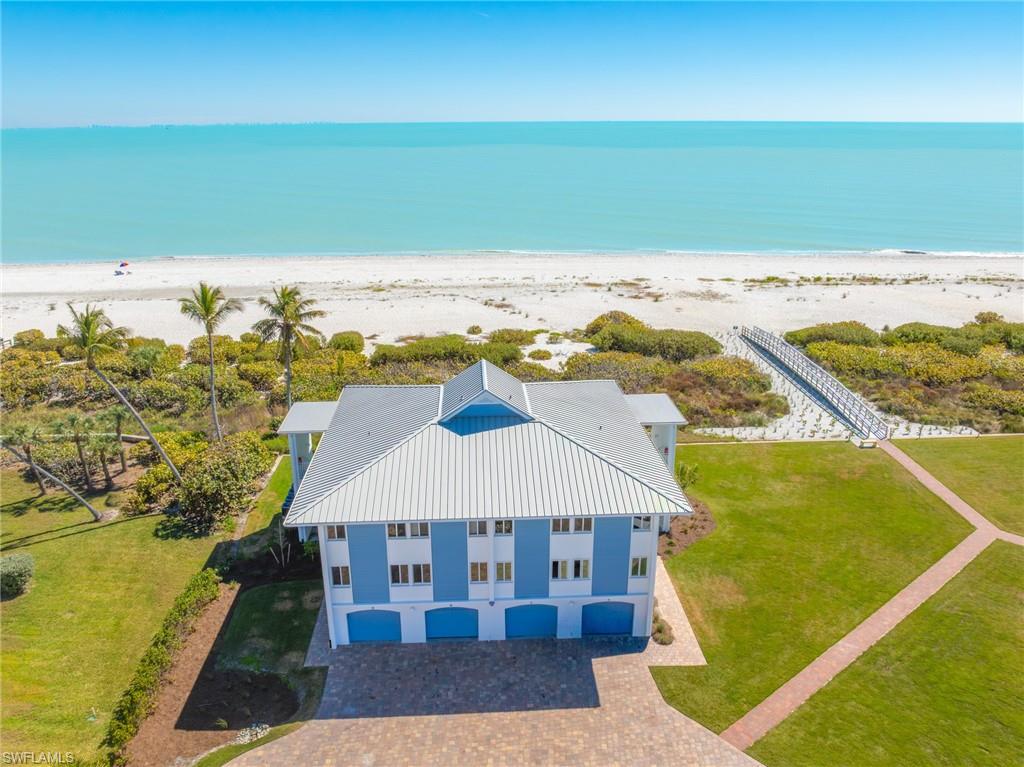 View from above of property featuring waterfront with a beach
