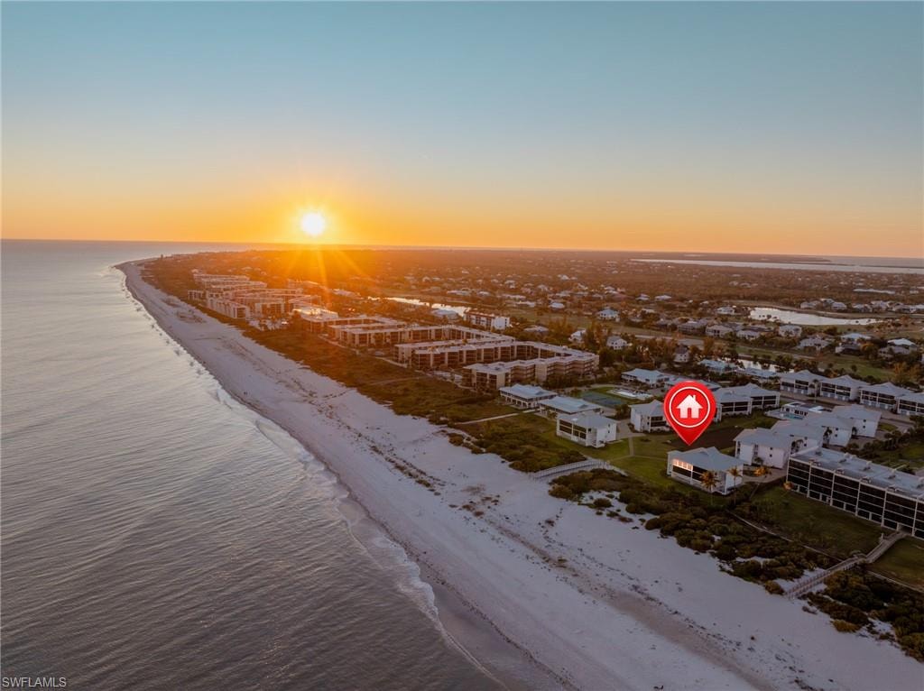 Aerial view at dusk of view of water and beach
