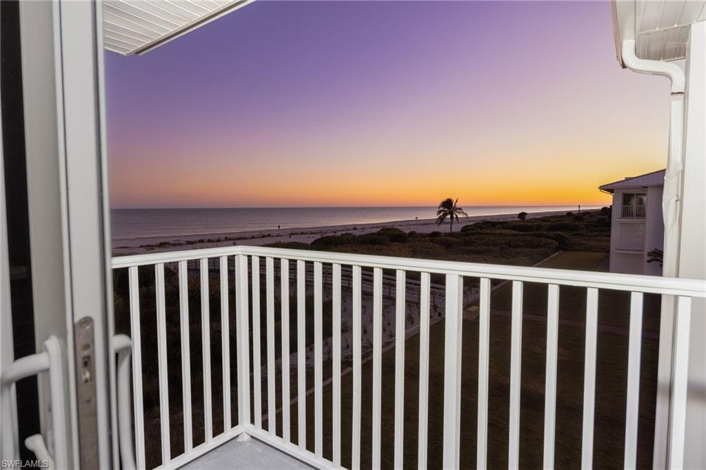 Balcony with view of water and beach
