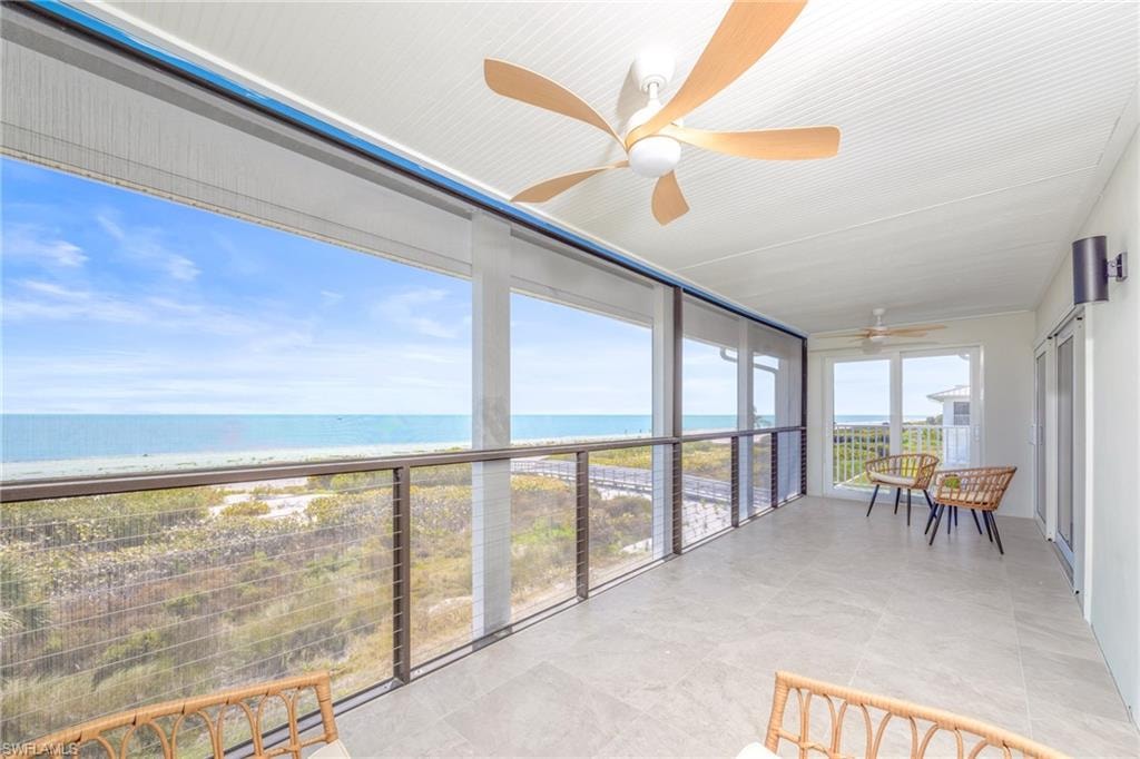 Sunroom / solarium featuring a water view