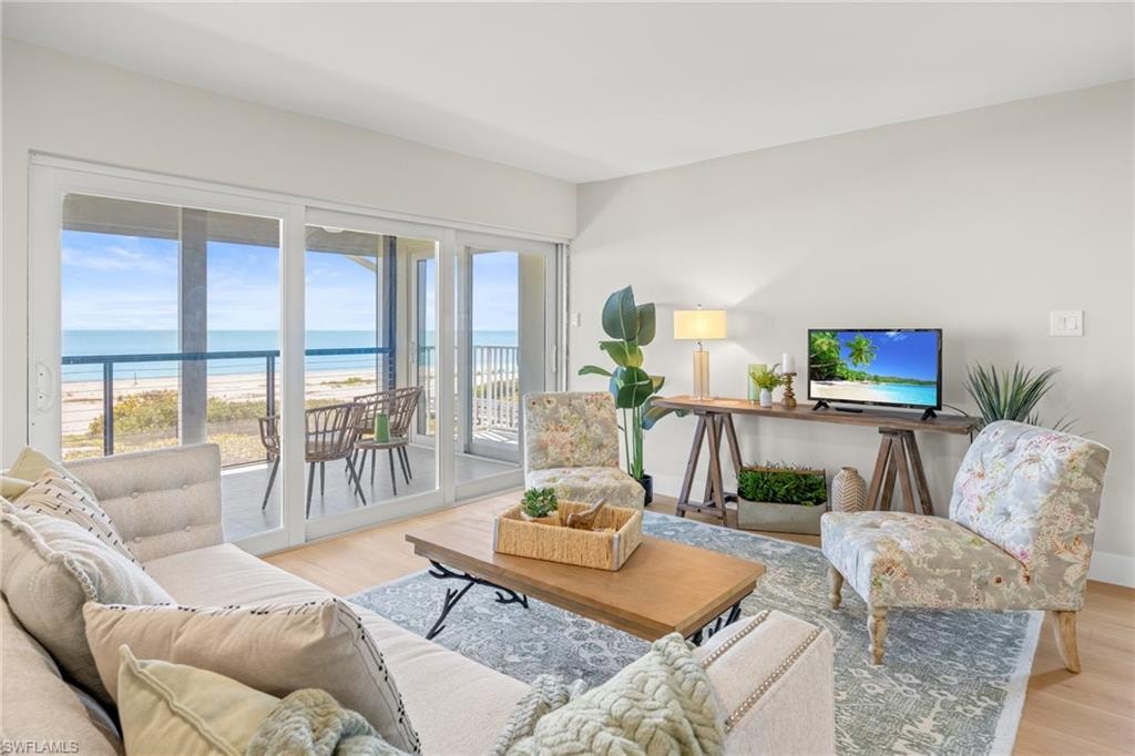 Living room featuring light wood finished floors and a beach view