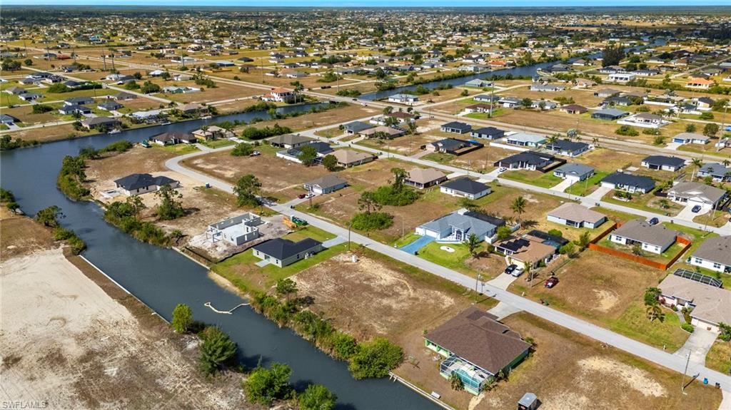 Aerial overview of property's location featuring nearby suburban area and a nearby body of water