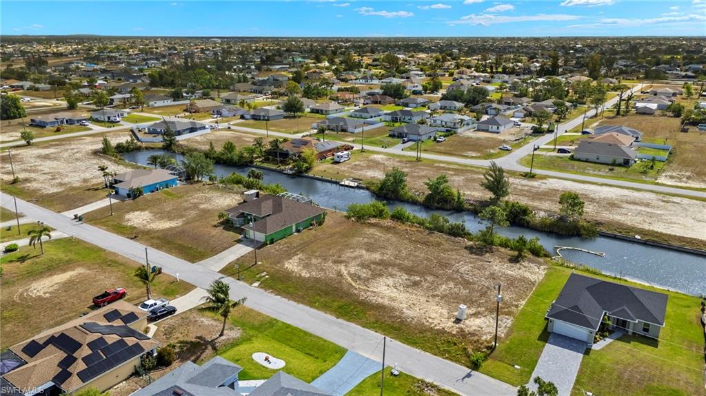 Aerial perspective of suburban area with a nearby body of water