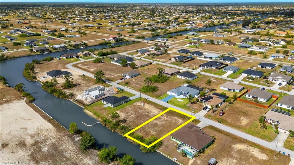 Aerial perspective of suburban area featuring a nearby body of water