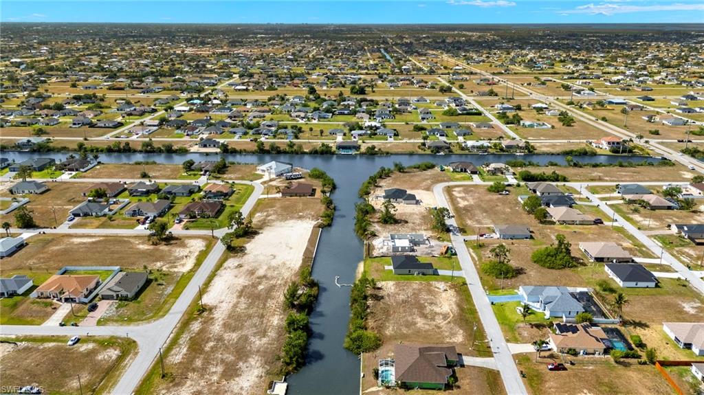 Aerial overview of property's location featuring nearby suburban area and a nearby body of water