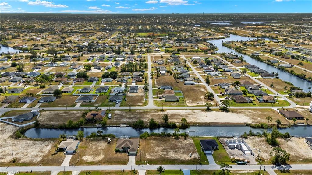 Aerial perspective of suburban area with a nearby body of water