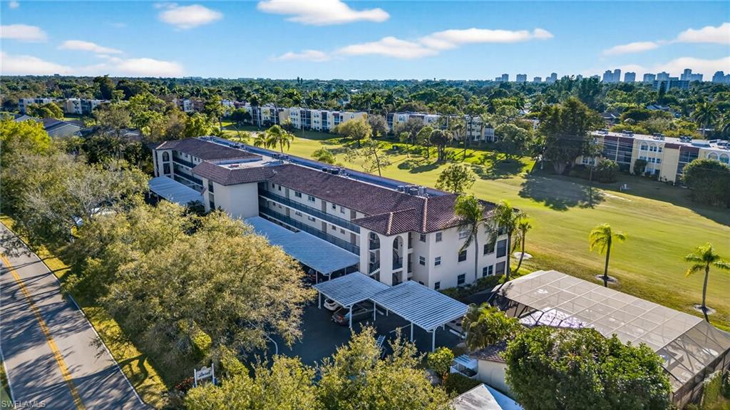 Bird's eye view of apartment complex / building and a local golf course