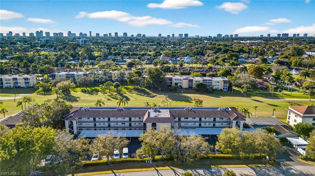 Bird's eye view of a golf course and city skyline