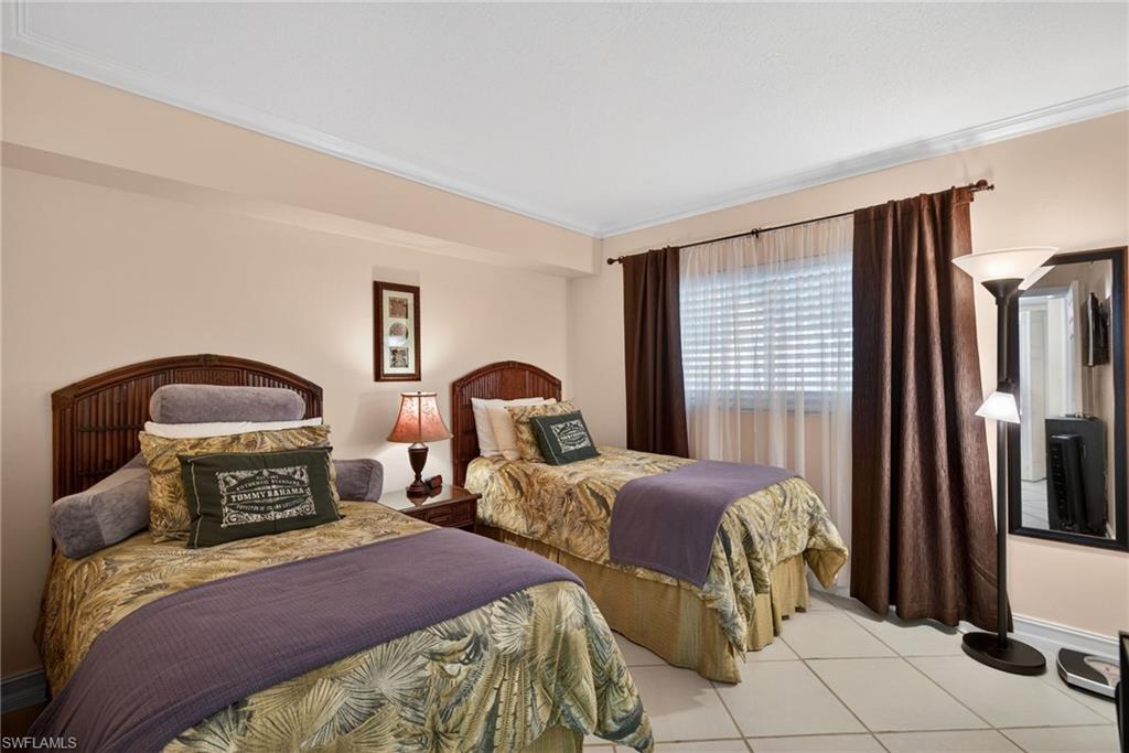 Bedroom featuring ornamental molding and light tile patterned floors