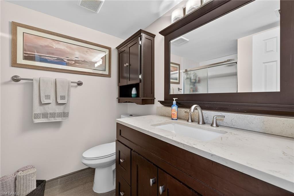 Full bath with vanity and a stall shower