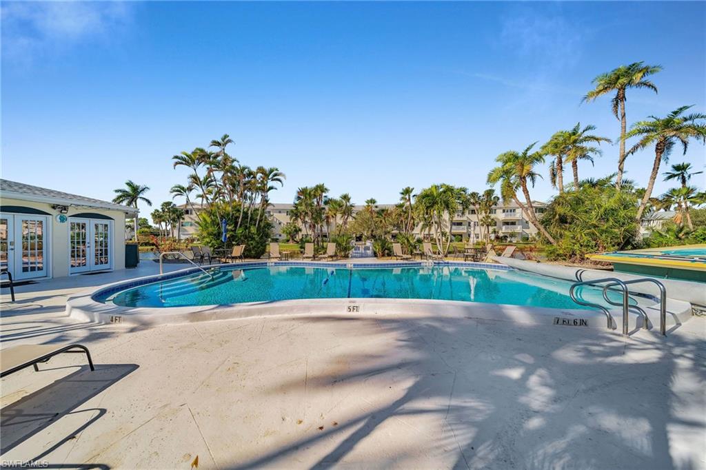 Community pool with a patio area and french doors