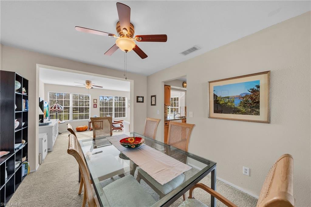 Dining area featuring carpet flooring and ceiling fan