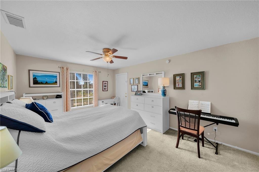 Bedroom with light carpet and ceiling fan