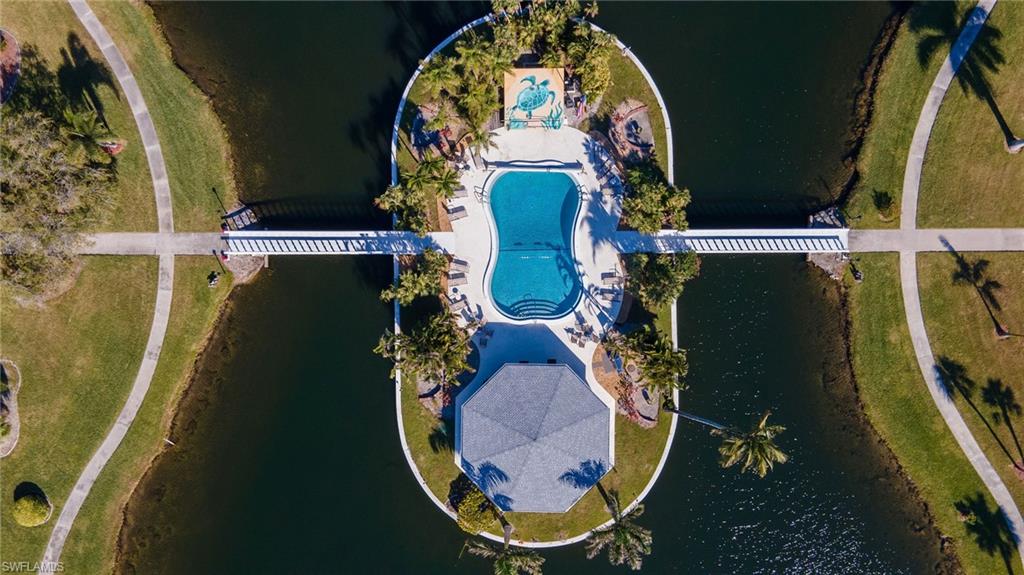 Aerial overview of property's location featuring a pool area and a nearby body of water