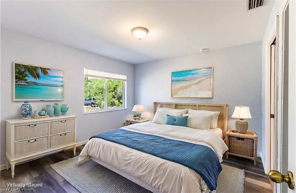 Bedroom featuring wood finished floors and baseboards