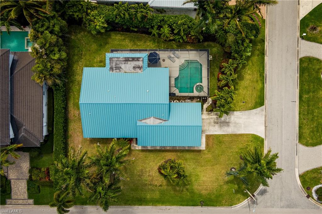 Aerial view of property and surrounding area featuring a pool