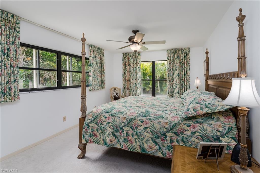 Carpeted bedroom featuring access to exterior and a ceiling fan