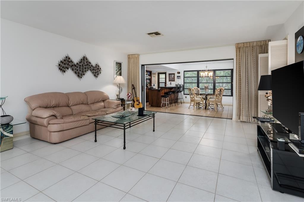 Living room with hanging lights and light tile patterned floors