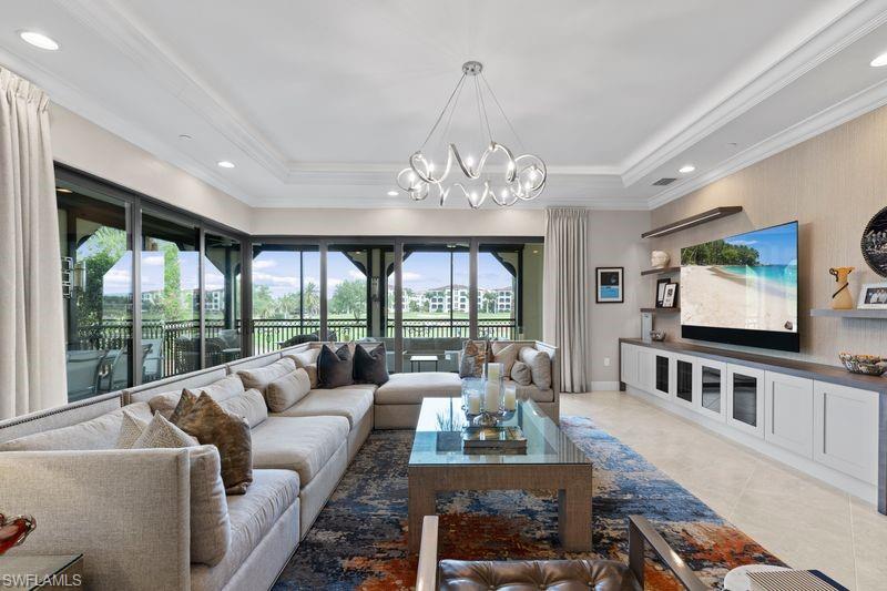 Living area featuring hanging lights and crown molding