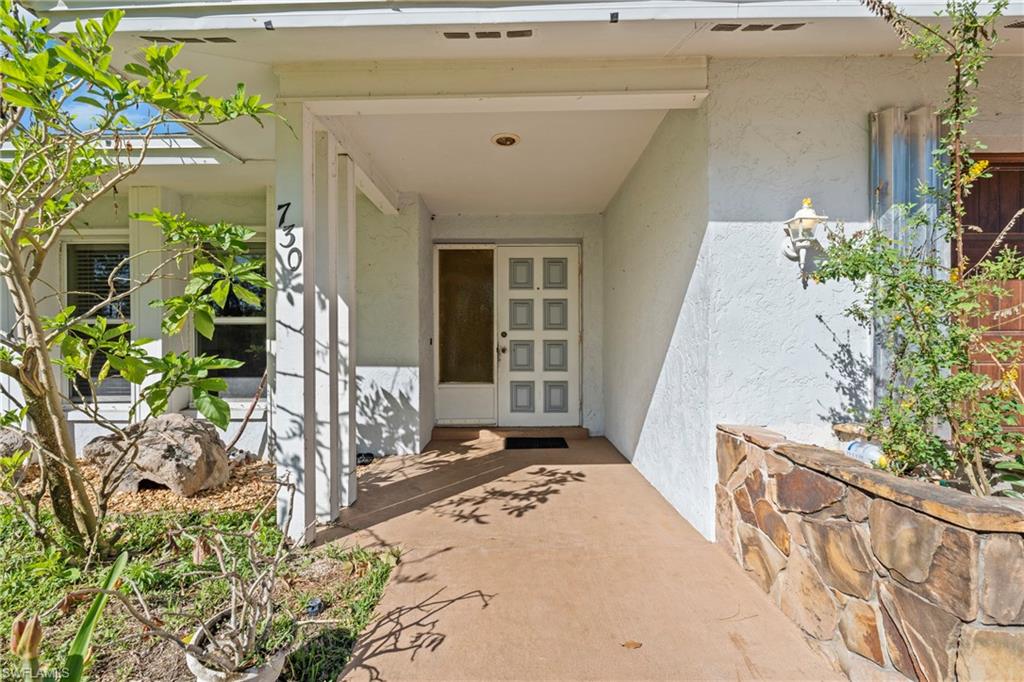 Entrance to property with stucco siding