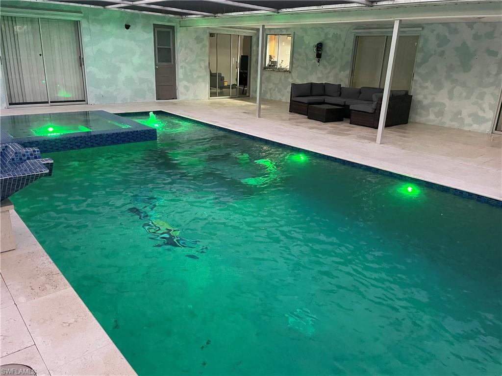 Integrated pool / hot tub with a patio area and an outdoor lounge area