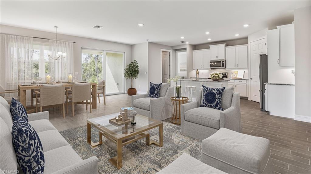 This image is virtually staged. Living area featuring wood finish floors and a chandelier