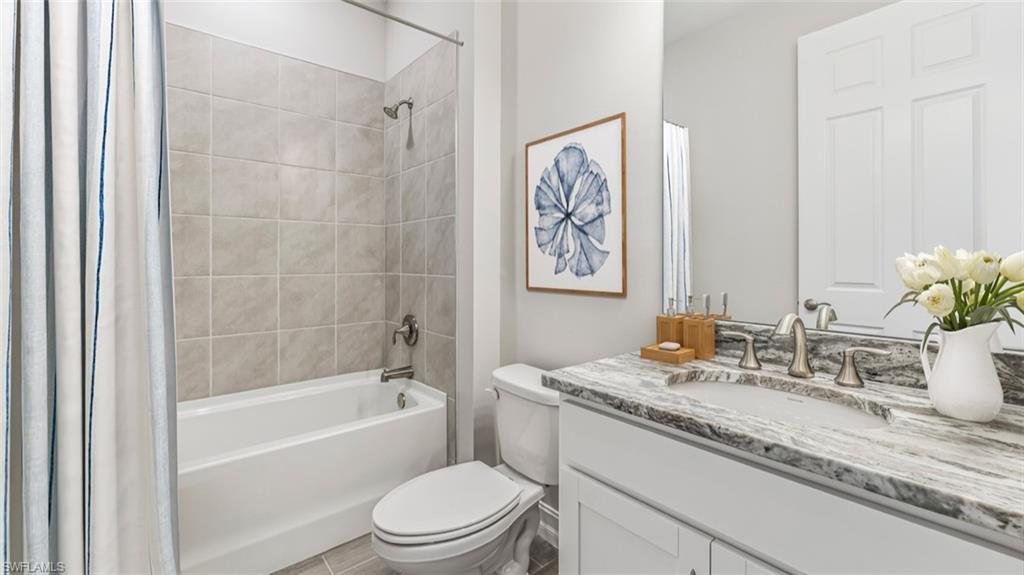 This image is virtually staged. Bathroom featuring vanity and shower / bath combo