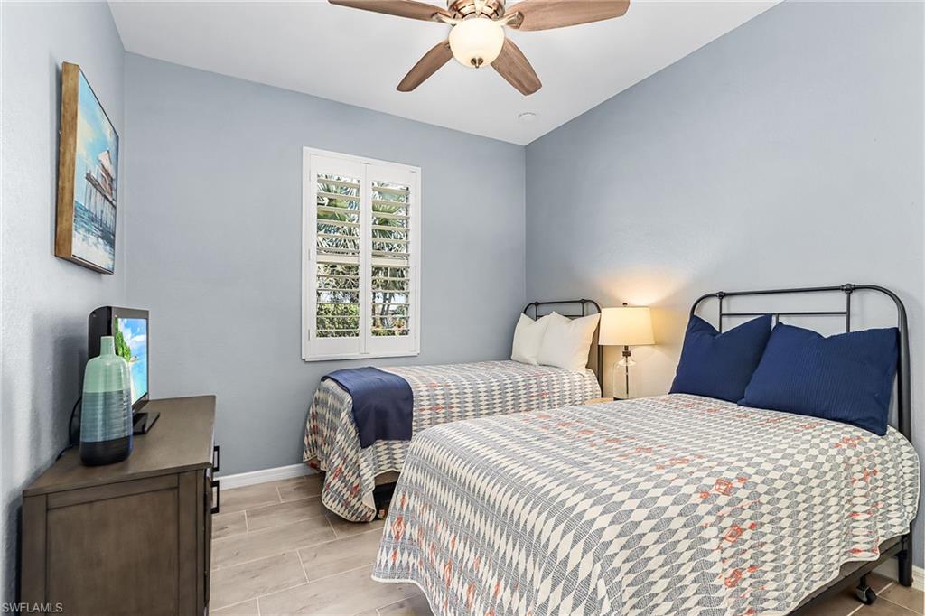 Bedroom with wood tiled floors and ceiling fan