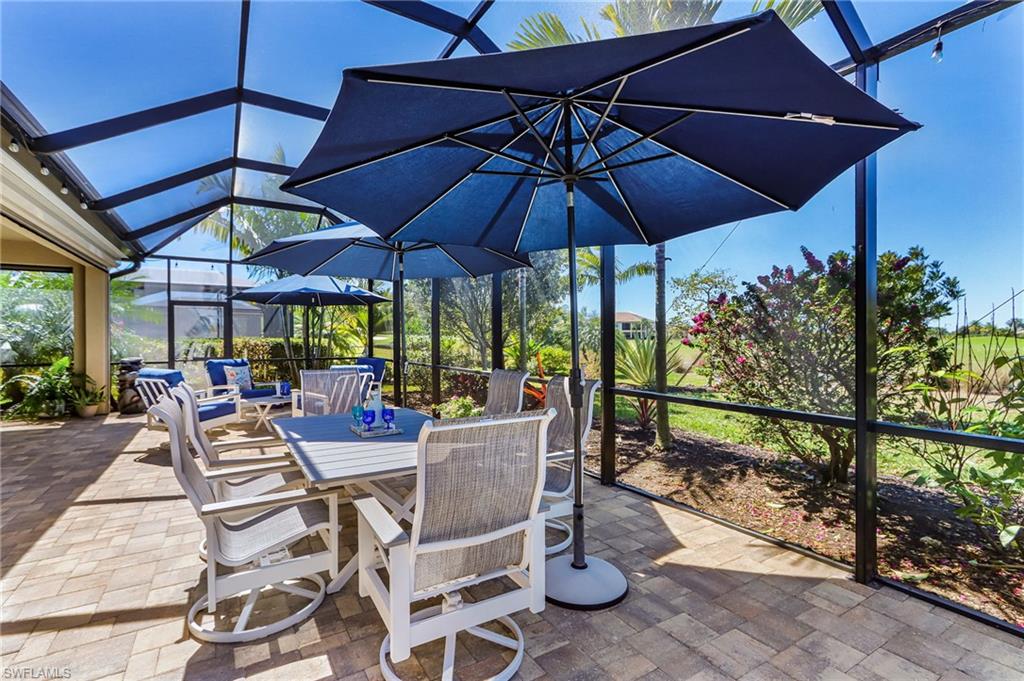 View of patio / terrace with a sunroom, a lanai, and outdoor dining area