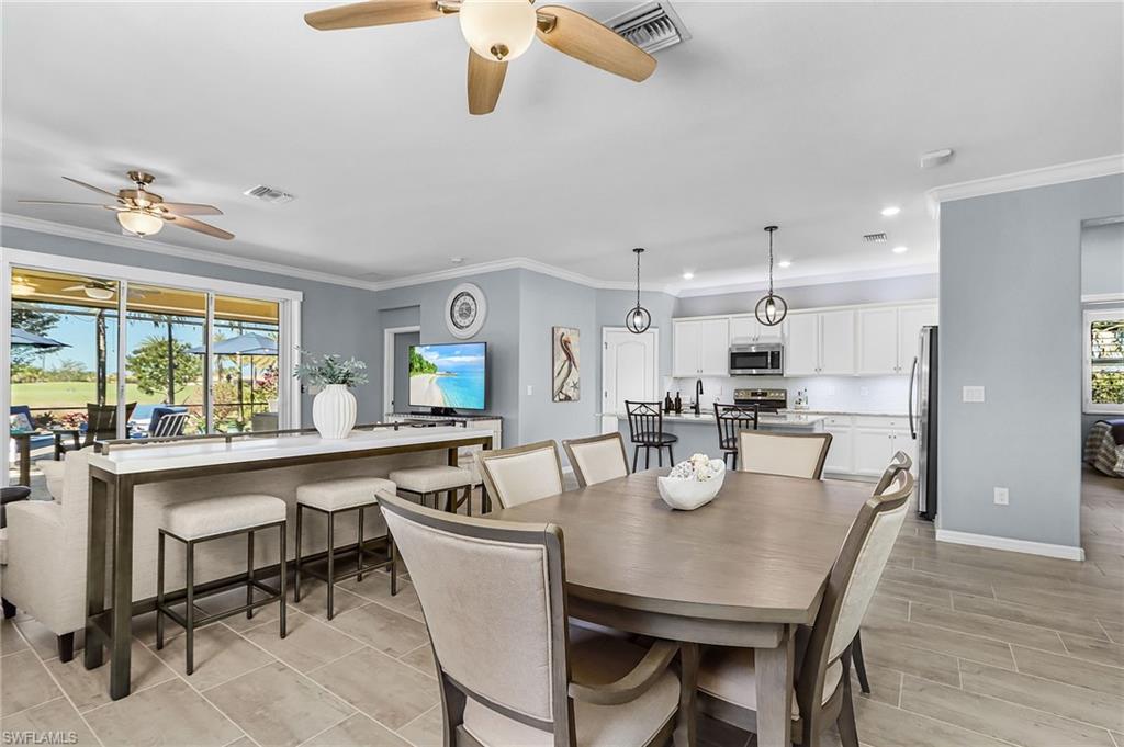 Dining space with ornamental molding, ceiling fan, recessed lighting, and wood finish floors
