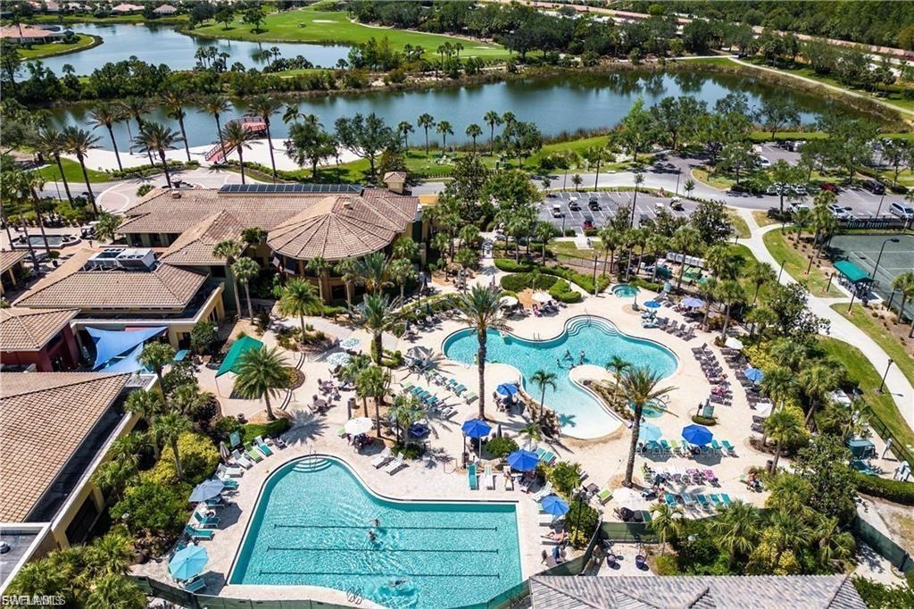 Bird's eye view of a pool area and a nearby body of water