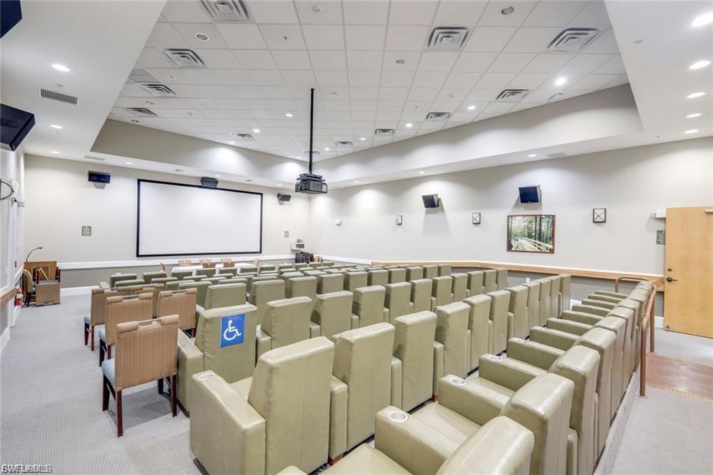 Cinema featuring light carpet, recessed lighting, and a paneled ceiling