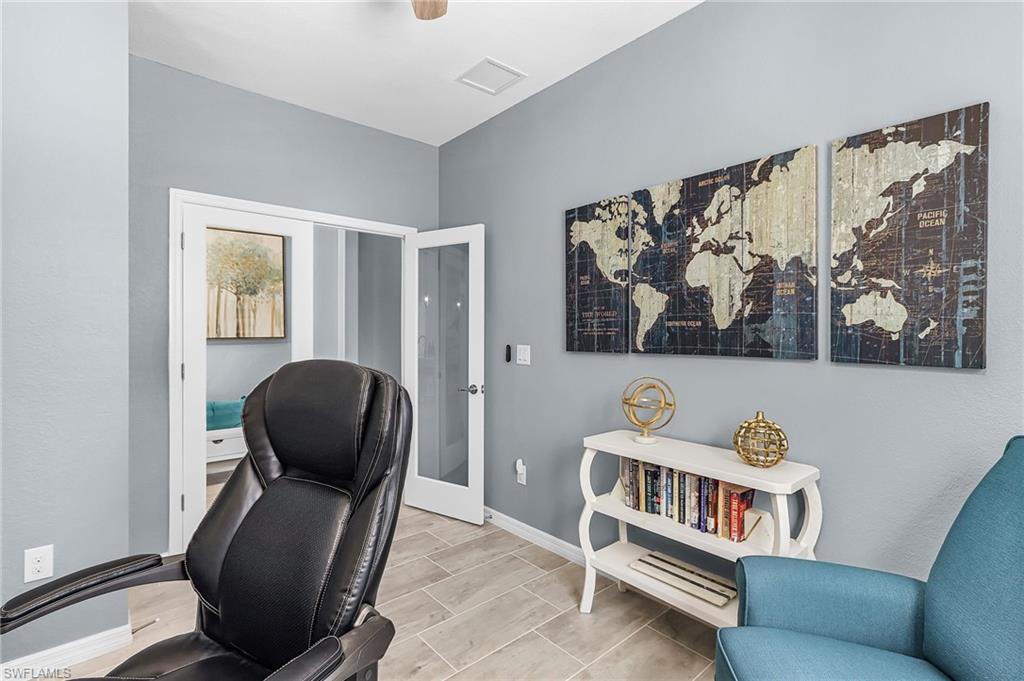 Office area with baseboards and wood tiled floors