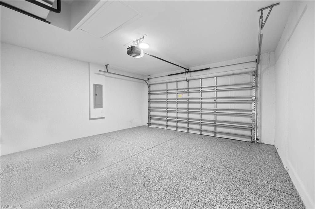 Garage with electric panel and a garage door opener
