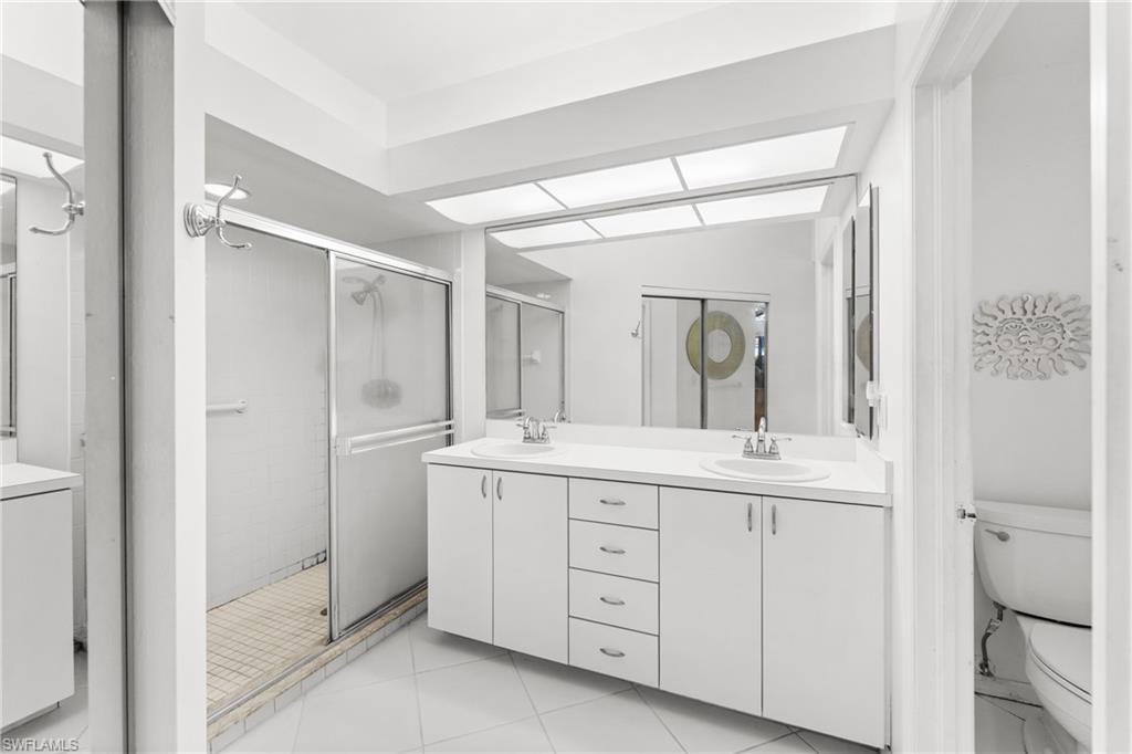 Bathroom with double vanity and a shower stall