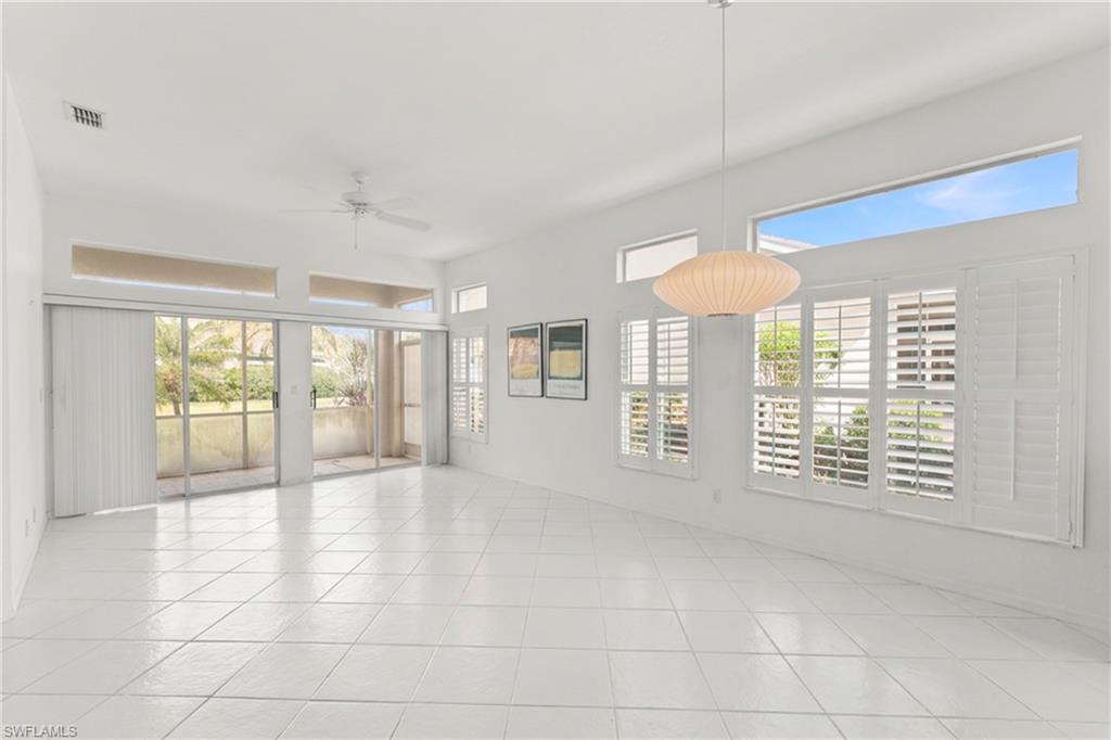 Empty room with a ceiling fan and light tile patterned floors
